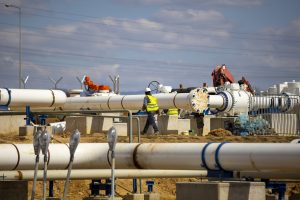Natural gas pipeline operator wearing safety gear.