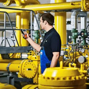 Safety professional using EX-TEC PM 400 to detect gas leaks in an industrial setting